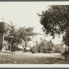 View of east side Main Street, north of Meeting House Lane. Brick building on left occupies site of hotel and "Howell House." Former church, now store, on right. Southampton, Southampton