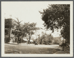 View of east side Main Street, north of Meeting House Lane. Brick building on left occupies site of hotel and "Howell House." Former church, now store, on right. Southampton, Southampton