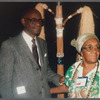 Mestre Didi standing with guest at the reception for his 1986 exhibition "Mestre Didi: An Afro-Brazilian Artist"