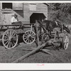 Black helper with wagon in front of J.V. Harris' barn, nine miles south of Chapel Hill on Highway 15. Chatham County, North Carolina.