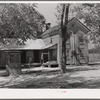 Old house and well about 100 years old, occupied by white farmer. Vertical boarding where chimney formerly was. Farrington, Chatham County, North Carolina.