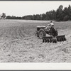 Emery Hooper, discing neighbor's land in preparation for planting fall wheat with equipment purchased with a FSA (Farm Security Administration) co-operative community service loan. Caswell County, North Carolina.