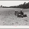 Emery Hooper, discing neighbor's land in preparation for planting fall wheat with equipment purchased with a FSA (Farm Security Administration) co-operative community service loan. Caswell County, North Carolina.