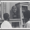 Young adults looking at W.E.B. DuBois bust in Schomburg Collection