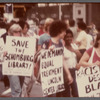 Group marching with signs at "Save the Schomburg" Rally 