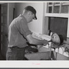 E. O. Foster's son (tenant purchase family) washing milk bottles in their Caswell dairy. Caswell County, North Carolina.