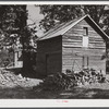 Storing barns and woodpiles on Emery Hooper's farm near Prospect Hill. Caswell County, North Carolina.