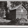 Storing barns and woodpiles on Emery Hooper's farm near Prospect Hill. Caswell County, North Carolina.