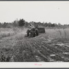 Harvesting soy bean seed on Roger's farm with a combine purchased by Emery M. Hooper thru an FSA Coop Community Service Loan.  Corbett Ridge section, Caswell County, North Carolina.