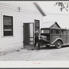 E.O. Foster's son taking the empty milk bottles out of their delivery wagon to be washed and refilled in the pasteurizing plant of their Caswell dairy. They are FSA (Farm Security Administration) tenant purchase borrowers. Caswell County, North Carolina.