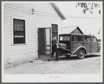 E.O. Foster's son taking the empty milk bottles out of their delivery wagon to be washed and refilled in the pasteurizing plant of their Caswell dairy. They are FSA (Farm Security Administration) tenant purchase borrowers. Caswell County, North Carolina.