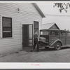 E.O. Foster's son taking the empty milk bottles out of their delivery wagon to be washed and refilled in the pasteurizing plant of their Caswell dairy. They are FSA (Farm Security Administration) tenant purchase borrowers. Caswell County, North Carolina.