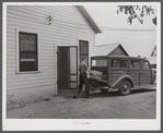 E.O. Foster's son taking the empty milk bottles out of their delivery wagon to be washed and refilled in the pasteurizing plant of their Caswell dairy. They are FSA (Farm Security Administration) tenant purchase borrowers. Caswell County, North Carolina.