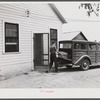 E.O. Foster's son taking the empty milk bottles out of their delivery wagon to be washed and refilled in the pasteurizing plant of their Caswell dairy. They are FSA (Farm Security Administration) tenant purchase borrowers. Caswell County, North Carolina.