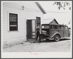 E.O. Foster's son taking the empty milk bottles out of their delivery wagon to be washed and refilled in the pasteurizing plant of their Caswell dairy. They are FSA (Farm Security Administration) tenant purchase borrowers. Caswell County, North Carolina.