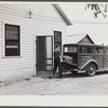 E.O. Foster's son taking the empty milk bottles out of their delivery wagon to be washed and refilled in the pasteurizing plant of their Caswell dairy. They are FSA (Farm Security Administration) tenant purchase borrowers. Caswell County, North Carolina.