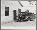 E.O. Foster's son taking the empty milk bottles out of their delivery wagon to be washed and refilled in the pasteurizing plant of their Caswell dairy. They are FSA (Farm Security Administration) tenant purchase borrowers. Caswell County, North Carolina.