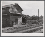 Tobacco barn, now used for storing supplies, on Emery Hooper's farm in Corbett Ridge section near Prospect Hill. Caswell County, North Carolina.