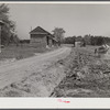 Spreading lime to increase productivity of soil before planting winter wheat on Emery M. Hopper's tobacco farm in Corbett Ridge section. Caswell County, North Carolina.