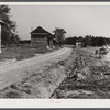 Spreading lime to increase productivity of soil before planting winter wheat on Emery M. Hopper's tobacco farm in Corbett Ridge section. Caswell County, North Carolina.