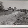 Spreading lime to increase productivity of soil before planting winter wheat on Emery M. Hopper's tobacco farm in Corbett Ridge section. Caswell County, North Carolina.