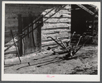 Plows in front of tobacco barn on Emery Hopper's farm in Corbett Ridge section. Caswell County, North Carolina.,