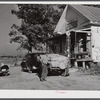 Farmer with load of tobacco which he is taking to market to be sold at auction in warehouse. This is in front of Carver's store. Corbett Ridge section, Caswell County, North Carolina.