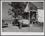 Farmer with load of tobacco which he is taking to market to be sold at auction in warehouse. This is in front of Carver's store. Corbett Ridge section, Caswell County, North Carolina.