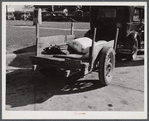 Farmer returning home after selling his tobacco at auction. In the trailer are sacks of flour and meal and the tobacco sticks. Yanceyville, Caswell County, North Carolina.