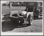 Farmer returning home after selling his tobacco at auction. In the trailer are sacks of flour and meal and the tobacco sticks. Yanceyville, Caswell County, North Carolina.