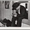 Fur buyer figuring out his bid on the next lot of muskrat pelts. The auction sale is held in a dance hall on Delacroix Island, Saint Bernard Parish, Louisiana.