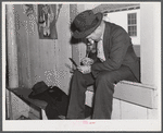 Fur buyer figuring out his bid on the next lot of muskrat pelts. The auction sale is held in a dance hall on Delacroix Island, Saint Bernard Parish, Louisiana.