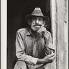 Spanish muskrat trapper in doorway of his marsh camp. Delacroix Island, Saint Bernard Parish, Louisiana