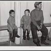 Fur trappers and his two children waiting for the bids on the next lot of muskrats to come in. The auction sale is being held in a dance hall on Delacroix Island, Saint Bernard Parish, Louisiana.
