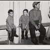Fur trappers and his two children waiting for the bids on the next lot of muskrats to come in. The auction sale is being held in a dance hall on Delacroix Island, Saint Bernard Parish, Louisiana.