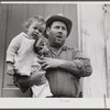French muskrat trapper with neighbor's child. Delacroix Island, Saint Bernard Parish, Louisiana.