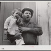 French muskrat trapper with neighbor's child. Delacroix Island, Saint Bernard Parish, Louisiana.