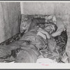Spanish muskrat trapper on his camp bed after too much whiskey and red wine. Delacroix Island, Saint Bernard Parish, Louisiana.