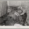 Spanish muskrat trapper on his camp bed after too much whiskey and red wine. Delacroix Island, Saint Bernard Parish, Louisiana.