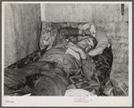 Spanish muskrat trapper on his camp bed after too much whiskey and red wine. Delacroix Island, Saint Bernard Parish, Louisiana.