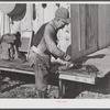 Spanish trapper skinning his muskrats before hanging them up to dry at the side of his marsh camp. Delacroix Island, Saint Bernard Parish, Louisiana.