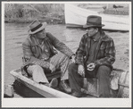 FSA (Farm Security Administration) supervisor talking to one of the trappers in his boat by one of the bayou marsh camps. Delacroix Island, Saint Bernard Parish, Louisiana.