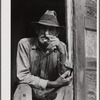 Spanish muskrat trapper in doorway of his marsh camp. Delacroix Island, Saint Bernard Parish, Louisiana.