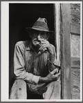 Spanish muskrat trapper in doorway of his marsh camp. Delacroix Island, Saint Bernard Parish, Louisiana.