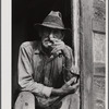Spanish muskrat trapper in doorway of his marsh camp. Delacroix Island, Saint Bernard Parish, Louisiana.