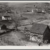 Noah Garland's barns and home on the hillside. His neighbor's house is on the right. Southern Appalachian Project near Barbourville, Knox County, Kentucky.