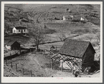 Noah Garland's barns and home on the hillside. His neighbor's house is on the right. Southern Appalachian Project near Barbourville, Knox County, Kentucky.