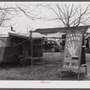 Fortune teller's sign and trailer near trailer camps where Army men and construction workers live on highway near Fort Benning, Columbus, Georgia.