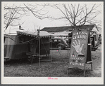 Fortune teller's sign and trailer near trailer camps where Army men and construction workers live on highway near Fort Benning, Columbus, Georgia.