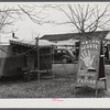 Fortune teller's sign and trailer near trailer camps where Army men and construction workers live on highway near Fort Benning, Columbus, Georgia.
